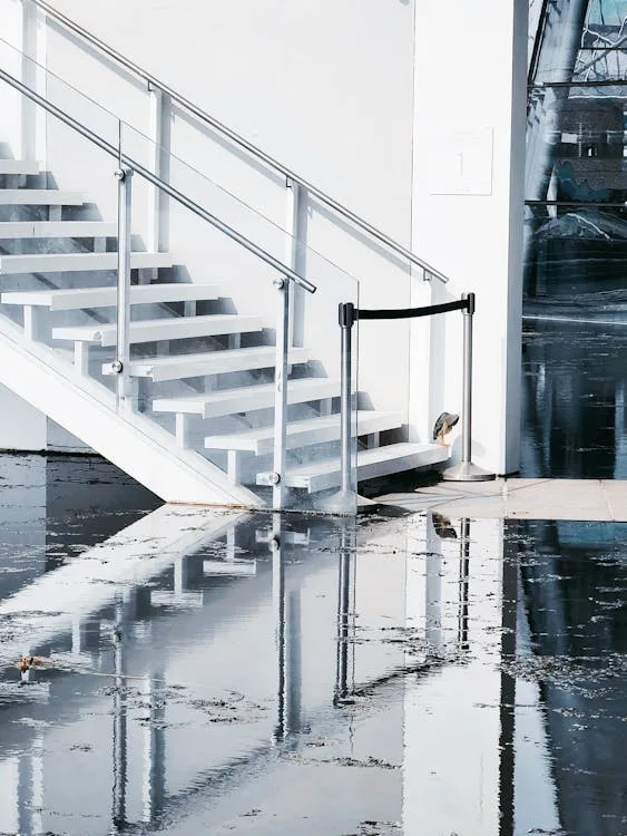 water damage restoration colorado springs colorado — technician extracting water from flooded basement